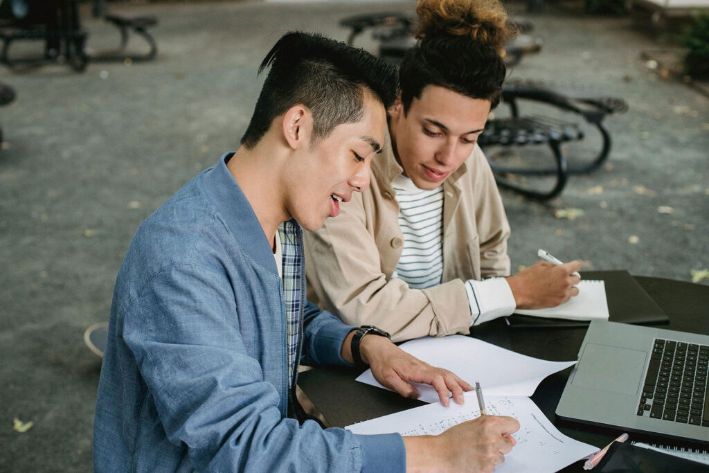 Two People Studying Outside at Table