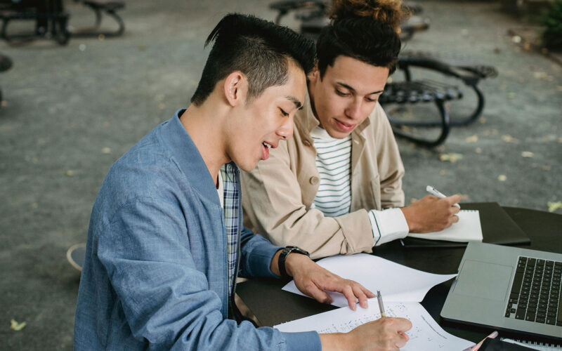Two People Studying Outside at Table